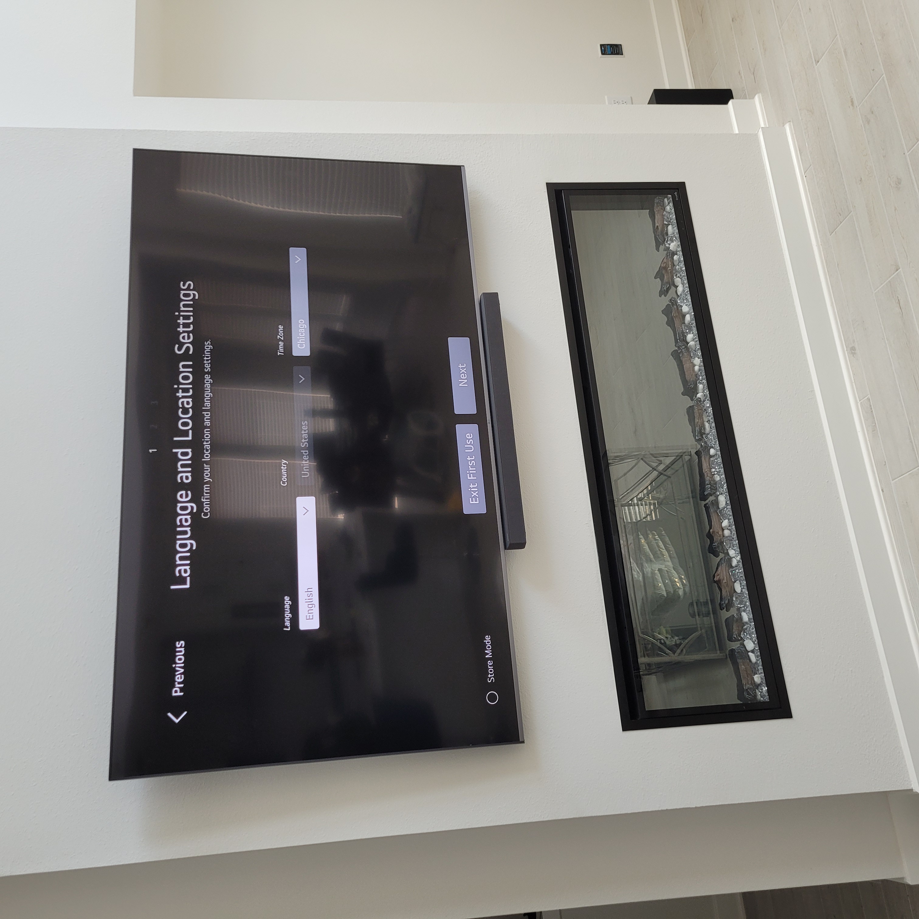 TV and soundbar mounted above modern horizontal linear electric fireplace